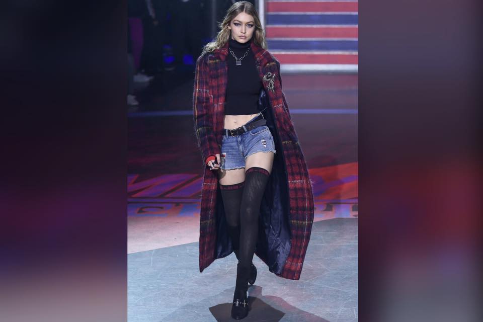 紅色格仔外套加黑色露臍樽領上衣下身配牛仔短褲和一對黑色過膝長襪。