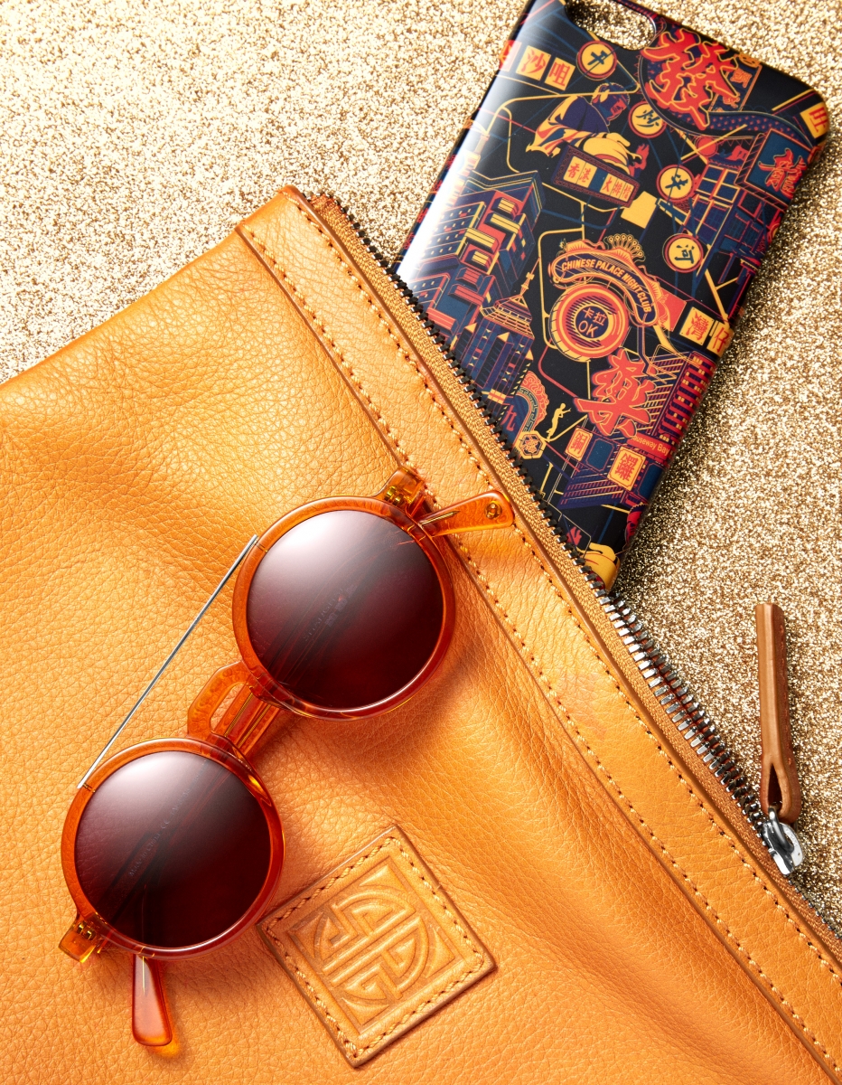 Retro Chinese round sunglasses in tangerine $2,980/New pebble media pouch $1,880/Hong Kong Queen iPhone 6 Plus case $398